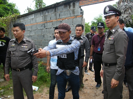 Sahas Butdoi reenacts the murder for police and reporters.
